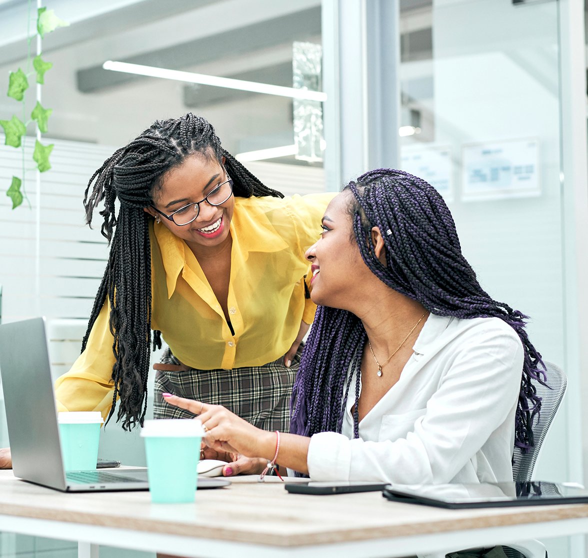 Two female employees chatting with eachother.