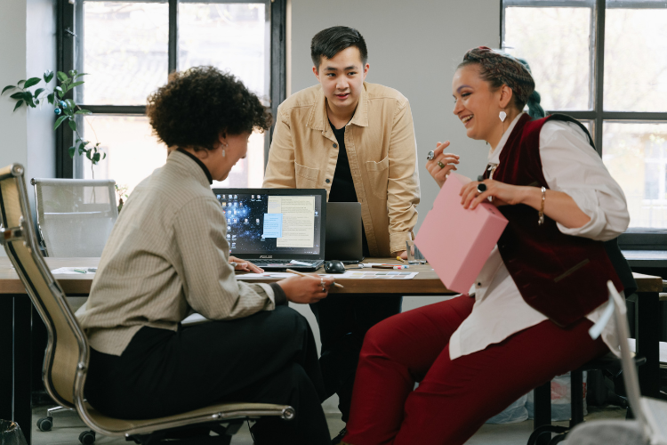 Coworkers chatting in an open-concept office.