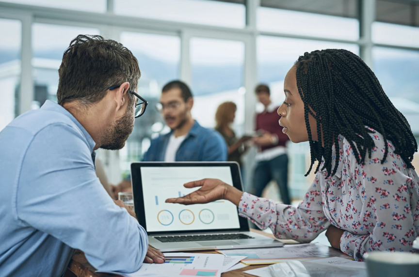 An image of two workers collaborating together on a project.