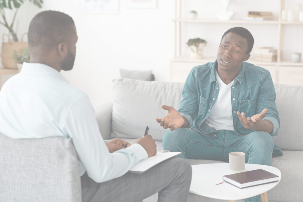 An image of a therapist talking to a workplace client.