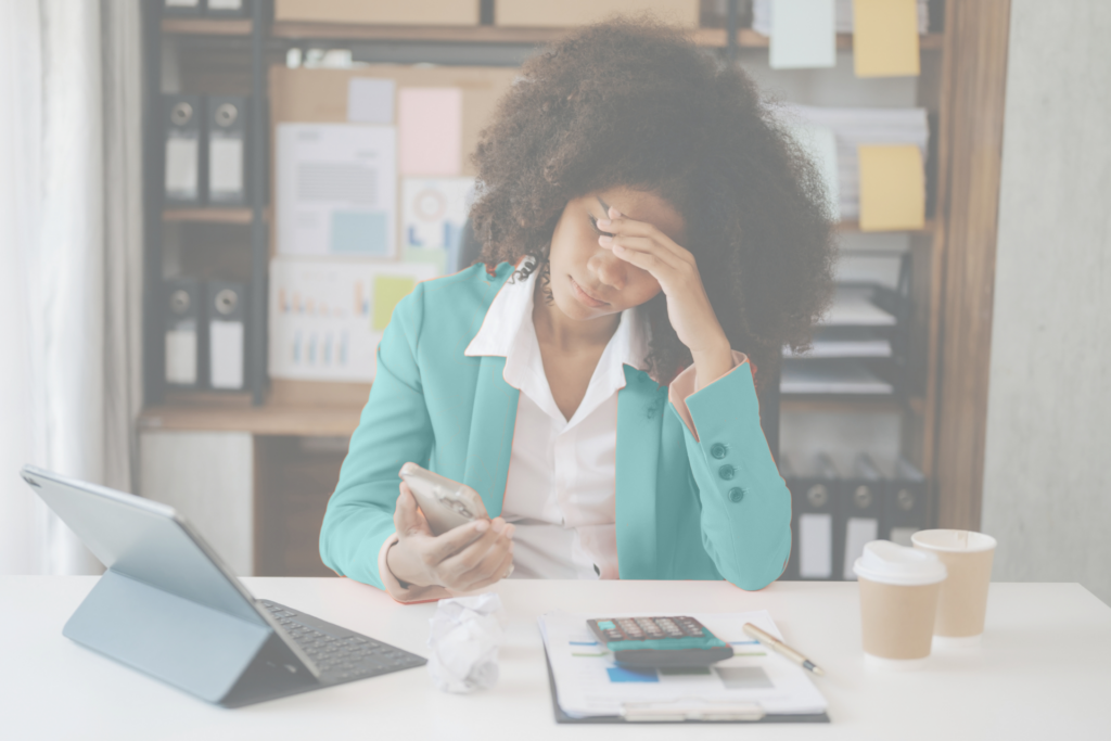 An image of a professional woman struggling with mental health issues in the workplace.