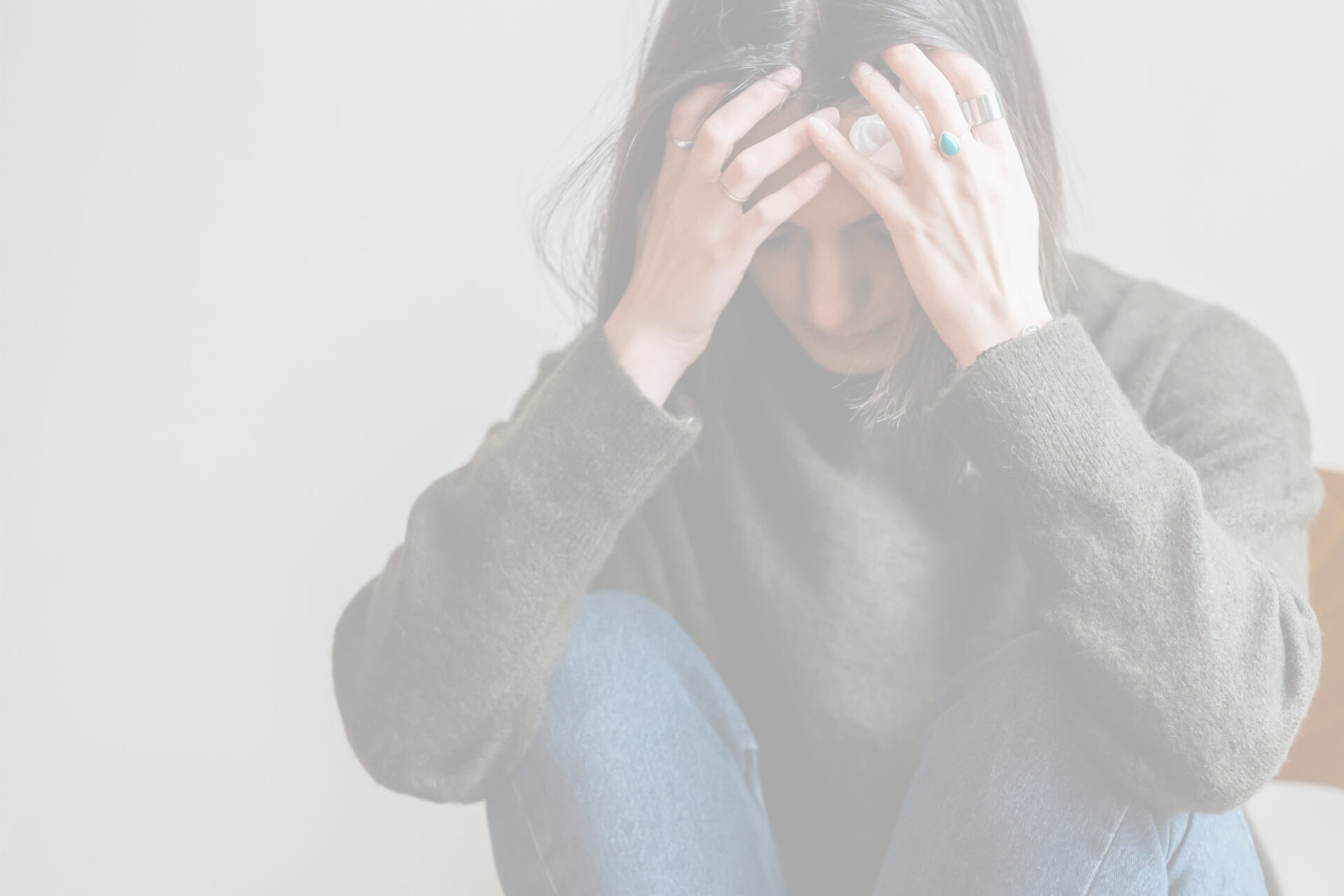 An image of someone covering their head with their hands.